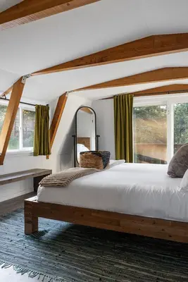 a bedroom with a large bed and a mirror at Beautiful A Frame Near Hiking And Red Rocks And Evergreen in Morrison