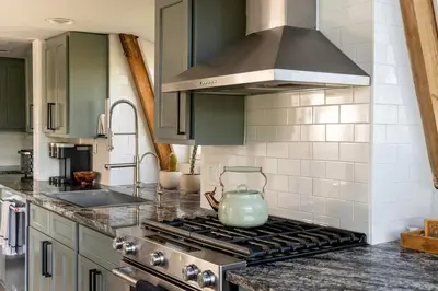 a kitchen with a stove with a tea kettle on it at Beautiful A Frame Near Hiking And Red Rocks And Evergreen in Morrison