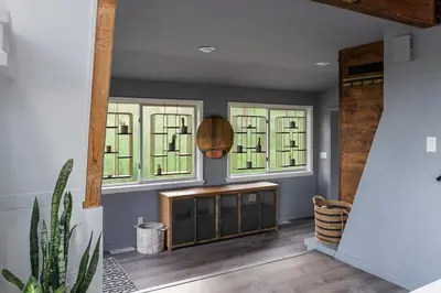 a living room with two windows and a wooden table at Beautiful A Frame Near Hiking And Red Rocks And Evergreen in Morrison