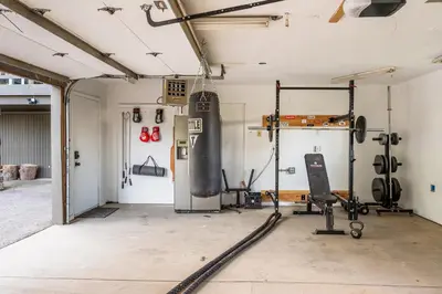an empty garage with a gym with equipment in it at Beautiful A Frame Near Hiking And Red Rocks And Evergreen in Morrison
