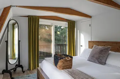 a bedroom with a bed and a large window at Beautiful A Frame Near Hiking And Red Rocks And Evergreen in Morrison