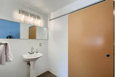 a bathroom with a sink and a mirror at New Hip Loft Near RiNo Taxi District With A Pool in Denver
