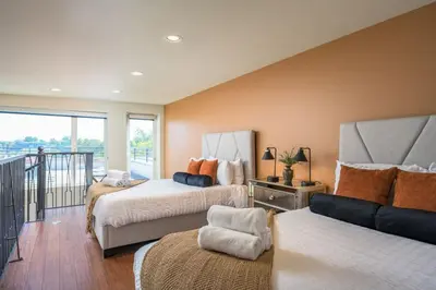 a bedroom with two beds and a balcony at RiNo Loft With Parking And Mountain Views in Denver