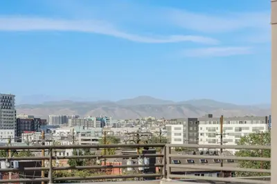 a view of a city from a balcony at RiNo Loft With Parking And Mountain Views in Denver
