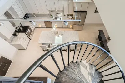 an overhead view of a kitchen with a spiral staircase at RiNo Loft With Parking And Mountain Views in Denver