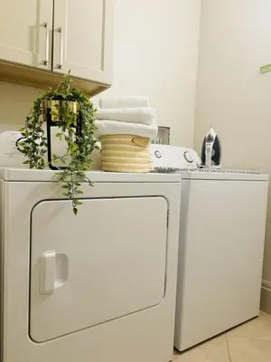 a white refrigerator with towels on top of it at Luxury Loft With Skyline Viwes In RiNo in Denver