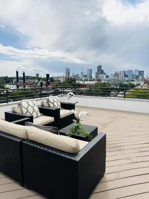 a patio with couches and tables on a roof at Luxury Loft With Skyline Viwes In RiNo in Denver