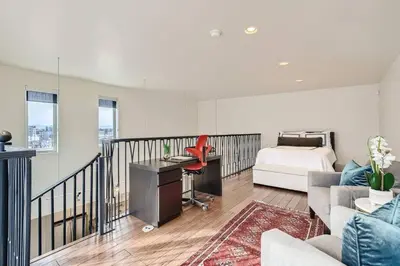 a bedroom with a bed and a desk in a room at Luxury Loft With Skyline Viwes In RiNo in Denver