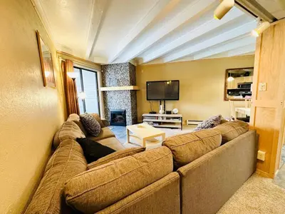 a living room with a large couch and a tv at Pet Friendly With A Fireplace A Pool Near Mountain Biking And Skiing in Silverthorne