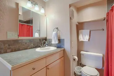 a bathroom with a sink and a toilet and a mirror at Pet Friendly With A Fireplace A Pool Near Mountain Biking And Skiing in Silverthorne