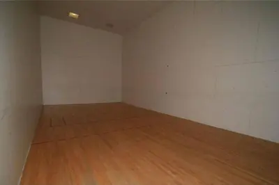 an empty room with a wooden floor and white walls at Pet Friendly With A Fireplace A Pool Near Mountain Biking And Skiing in Silverthorne
