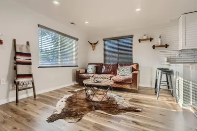 a living room with a couch and a table at Pet Friendly In West Denver Bungalow Near Meow Wolf in Denver
