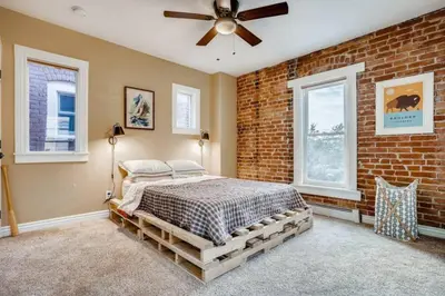 a bedroom with a brick wall and a bed at Central Denver Townhome Close To Historic Neighborhood in Denver