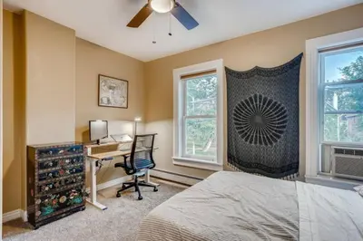 a bedroom with a bed and a desk and a window at Central Denver Townhome Close To Historic Neighborhood in Denver
