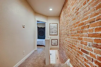 a room with a brick wall and a bedroom at Central Denver Townhome Close To Historic Neighborhood in Denver