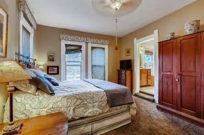 a bedroom with a large bed and a window at Artsy Victorian Great Location And Amazing Outdoor Space in Denver