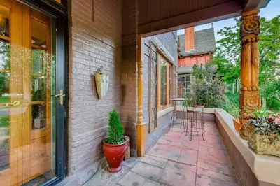 a porch with a potted plant next to a door at Artsy Victorian Great Location And Amazing Outdoor Space in Denver