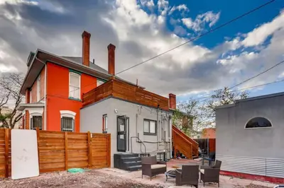 an orange and white house with a wooden fence at Guest Suite With Kitchenette And A 5 star Location in Denver