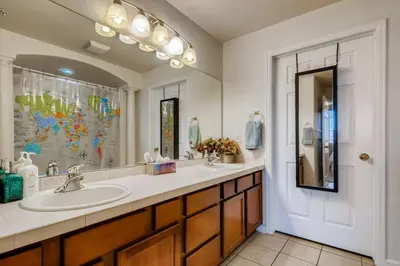 a bathroom with a sink and a large mirror at Capital Hill Condo 5 star location With Balcony in Denver