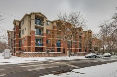 a large brick building on a city street in the snow at Capital Hill Condo 5 star location With Balcony in Denver