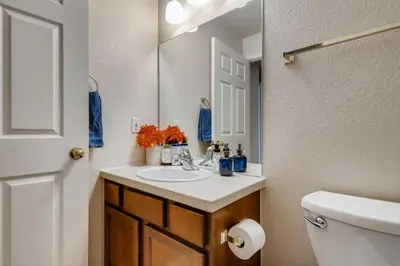 a bathroom with a sink and a toilet and a mirror at Capital Hill Condo 5 star location With Balcony in Denver