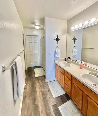 a bathroom with two sinks and a large mirror at Spacious Oasis near Red Rocks and Downtown Denver in Lakewood