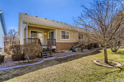 a small yellow house with a tree in the yard at Spacious Oasis near Red Rocks and Downtown Denver in Lakewood