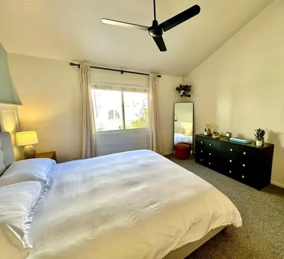 a bedroom with a large white bed and a window at Spacious Oasis near Red Rocks and Downtown Denver in Lakewood