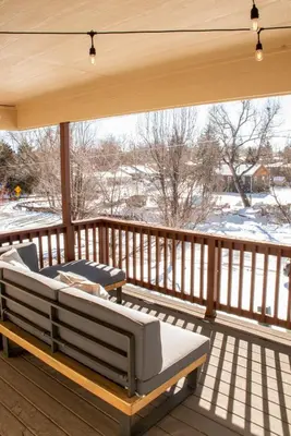 a porch with two lounge chairs on a deck at Spacious Oasis near Red Rocks and Downtown Denver in Lakewood