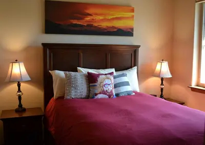 a bedroom with a purple bed with two lamps at Luxury condo with stunning views! in Fraser
