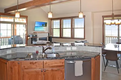 a kitchen with a sink and a counter top at Luxury condo with stunning views! in Fraser