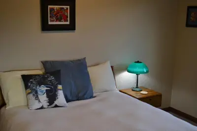 a bedroom with a bed and a lamp on a table at Luxury condo with stunning views! in Fraser