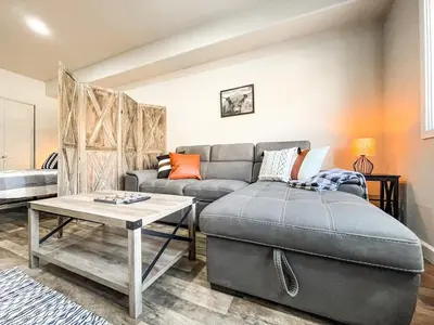 a living room with a couch and a table at Cozy Mountain Suite - hot tub, pool, gym - mins to lift in Keystone