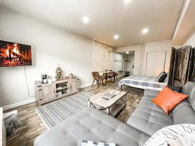 a living room with a couch and a table at Cozy Mountain Suite - hot tub, pool, gym - mins to lift in Keystone