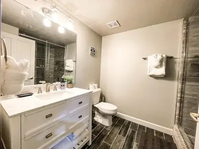 a bathroom with a sink and a toilet and a shower at Cozy Mountain Suite - hot tub, pool, gym - mins to lift in Keystone