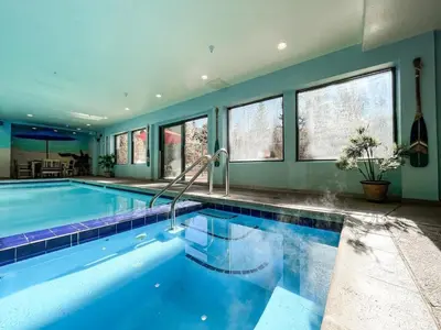 a large swimming pool in a house at Cozy Mountain Suite - hot tub, pool, gym - mins to lift in Keystone