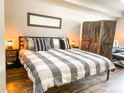 a bedroom with a bed with black and white pillows at Cozy Mountain Suite - hot tub, pool, gym - mins to lift in Keystone