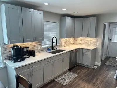 a kitchen with white cabinets and a sink at Island in the City - AWESOME 3 BR 2 BA 15 Min from DIA DT Anschutz in Commerce City