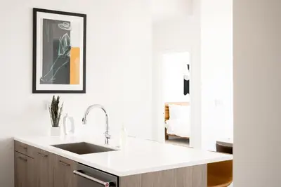 a kitchen with white countertops and a sink at 2880 U505 Skytop Perspective at Espadin in Denver