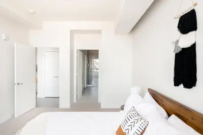 a white room with a bed and a hallway at 2880 U505 Skytop Perspective at Espadin in Denver