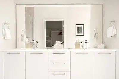 a white bathroom with a sink and a mirror at 2880 U505 Skytop Perspective at Espadin in Denver