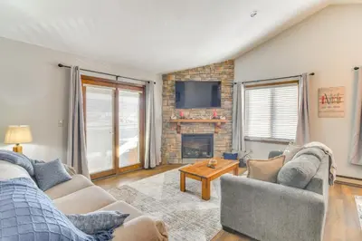 a living room with two couches and a fireplace at Family-Friendly Retreat with Balcony in Fraser! in Fraser