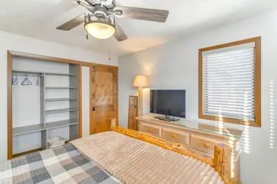 a bedroom with a bed and a flat screen tv at Family-Friendly Retreat with Balcony in Fraser! in Fraser