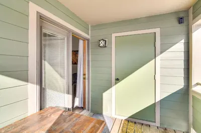 a room with a wooden table and a door at Family-Friendly Retreat with Balcony in Fraser! in Fraser