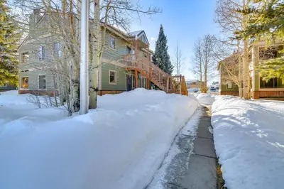 a snow covered street in front of some houses at Family-Friendly Retreat with Balcony in Fraser! in Fraser