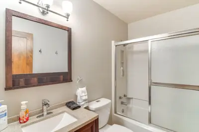 a bathroom with a toilet and a sink and a shower at Family-Friendly Retreat with Balcony in Fraser! in Fraser