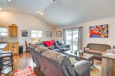 a living room with couches and a table at Hike, Ski and Explore Townhome with Yard in Fraser! in Fraser