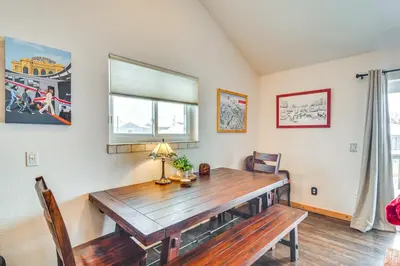 a dining room with a wooden table and a window at Hike, Ski and Explore Townhome with Yard in Fraser! in Fraser