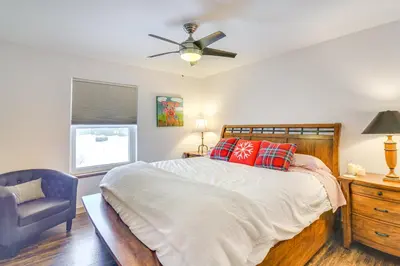 a bedroom with a bed with a ceiling fan and a chair at Hike, Ski and Explore Townhome with Yard in Fraser! in Fraser