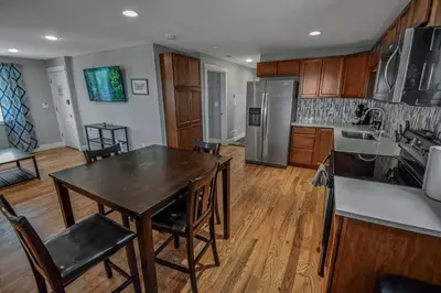a kitchen with a table and chairs in a room at 3 bed home with huge yard near Hidden Lake in Denver